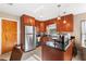 Kitchen with stainless steel refrigerator, custom cabinets and granite countertops, featuring a convenient gas range at 3622 W Mullen Ave, Tampa, FL 33609