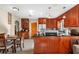 Charming kitchen features wood cabinets, black countertops, stainless steel appliances, and breakfast table at 3622 W Mullen Ave, Tampa, FL 33609