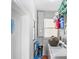 Functional laundry room with washer, dryer, and storage shelves at 3622 W Mullen Ave, Tampa, FL 33609