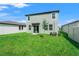 Expansive green backyard with sliding glass door and manicured lawn at 3655 Moscato Dr, Brooksville, FL 34602