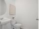 A clean half bathroom featuring a pedestal sink and framed art piece at 3655 Moscato Dr, Brooksville, FL 34602