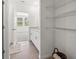 Bright bathroom with modern vanity, tile flooring, and open shelving at 3655 Moscato Dr, Brooksville, FL 34602