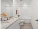 Bright bathroom with double vanity, granite counters, and a shower-tub combination at 3655 Moscato Dr, Brooksville, FL 34602