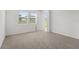 Bright bedroom with carpet and windows, offering plenty of natural light at 3655 Moscato Dr, Brooksville, FL 34602
