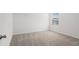 A cozy bedroom featuring plush carpeting, a bright window, and neutral tones at 3655 Moscato Dr, Brooksville, FL 34602
