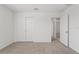 Bright bedroom featuring neutral carpet and a spacious closet with sliding doors at 3655 Moscato Dr, Brooksville, FL 34602