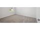 Bedroom featuring neutral carpet, base trim, and one window at 3655 Moscato Dr, Brooksville, FL 34602