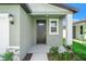 Close-up of the front door featuring a covered entry, side window, and welcoming facade at 3655 Moscato Dr, Brooksville, FL 34602