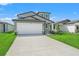 A charming two-story home with a paved driveway and manicured front yard at 3655 Moscato Dr, Brooksville, FL 34602