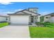 A lovely home featuring a two car garage and manicured front yard at 3655 Moscato Dr, Brooksville, FL 34602