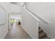 Bright hallway with staircase leading to an open-concept kitchen and dining area at 3655 Moscato Dr, Brooksville, FL 34602