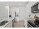 Well-equipped kitchen with stainless steel appliances, granite countertops, and white cabinetry at 3655 Moscato Dr, Brooksville, FL 34602