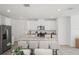 Spacious kitchen featuring an island with bar stools and stainless steel appliances at 3655 Moscato Dr, Brooksville, FL 34602