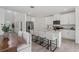 Open-concept kitchen featuring white cabinets, granite countertops, stainless appliances, and an island with barstool seating at 3655 Moscato Dr, Brooksville, FL 34602