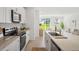 Modern kitchen featuring stainless steel appliances, granite countertops, and a large island at 3655 Moscato Dr, Brooksville, FL 34602