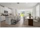 Open layout featuring the living room, dining area, and kitchen with plenty of natural light and modern finishes at 3655 Moscato Dr, Brooksville, FL 34602