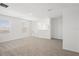 Loft area featuring neutral carpet, two windows, and stairs with railing at 3655 Moscato Dr, Brooksville, FL 34602