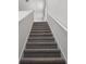 Carpeted staircase with neutral tones leading to the upper level of the home at 3655 Moscato Dr, Brooksville, FL 34602