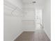 Carpeted walk-in closet with metal shelving and views of the bathroom at 3655 Moscato Dr, Brooksville, FL 34602