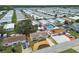 Aerial view showcases the home with a patio, pool, and lake views at 3850 Carioca Rd, Holiday, FL 34691