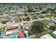 Overhead view of the community showing the house with pool, solar panels, and lake views at 3850 Carioca Rd, Holiday, FL 34691