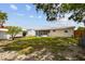 The backyard features a screened-in porch, wooden fence, mature trees, and ample green space at 3850 Carioca Rd, Holiday, FL 34691