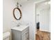 Bathroom features modern sink and vanity with an oval wooden-framed mirror at 3850 Carioca Rd, Holiday, FL 34691