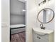 Bathroom with modern sink and open doorway view to a bedroom with a comfortable bed and wood flooring at 3850 Carioca Rd, Holiday, FL 34691