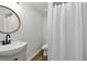 Cozy bathroom with a modern sink, updated fixtures, and a classic shower curtain at 3850 Carioca Rd, Holiday, FL 34691