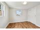 Bedroom with hardwood floors, white trim, and a closet for ample storage space at 3850 Carioca Rd, Holiday, FL 34691