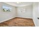 Bright bedroom with hardwood floors and two windows providing natural light at 3850 Carioca Rd, Holiday, FL 34691