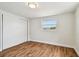 Bedroom with wood floors, sliding-door closet and bright light from the large window at 3850 Carioca Rd, Holiday, FL 34691