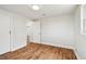 Bedroom featuring hardwood floors, white trim, closet and entry doors at 3850 Carioca Rd, Holiday, FL 34691