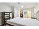 Well-lit bedroom featuring a large bed, modern dresser, and convenient access to the laundry area at 3850 Carioca Rd, Holiday, FL 34691