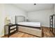Comfortable bedroom features hardwood floors, a cushioned headboard, and side tables at 3850 Carioca Rd, Holiday, FL 34691