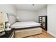 Comfortable bedroom featuring a large bed with light-colored headboard and wood-look flooring at 3850 Carioca Rd, Holiday, FL 34691