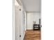 Bedroom hallway features hardwood floors and opens to a bedroom with stylish decor at 3850 Carioca Rd, Holiday, FL 34691