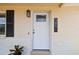 Close-up of the front door with modern light fixture and house number at 3850 Carioca Rd, Holiday, FL 34691