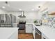 Well-lit kitchen showcasing stainless appliances, stone backsplash and ample counter space at 3850 Carioca Rd, Holiday, FL 34691