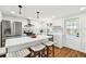 Bright kitchen features an island with seating, modern stainless appliances, and beautiful geometric patterned backsplash at 3850 Carioca Rd, Holiday, FL 34691