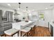 Modern kitchen with an island, stainless steel appliances, and designer tile backsplash at 3850 Carioca Rd, Holiday, FL 34691