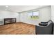 Bright living room featuring wood floors, modern furniture, and plenty of natural light at 3850 Carioca Rd, Holiday, FL 34691