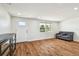 Bright living room featuring wood floors, updated furniture, and plenty of natural light at 3850 Carioca Rd, Holiday, FL 34691