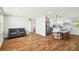 Open-concept living room showcasing wood floors, modern furniture, and seamless flow to the kitchen at 3850 Carioca Rd, Holiday, FL 34691
