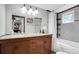 Well-lit bathroom featuring a double vanity, granite countertop, and a shower-tub combination at 4044 56Th N Ave, St Petersburg, FL 33714