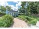 Charming shed with a brick path, set amidst a lush green yard with blooming flowers at 4044 56Th N Ave, St Petersburg, FL 33714