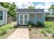 Backyard shed featuring a quaint, rustic design with brick pavers and lush greenery at 4044 56Th N Ave, St Petersburg, FL 33714