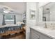 Bathroom featuring a vanity, and a view into the bedroom featuring a wrought iron bed frame at 4108 Woodtrail Blvd, New Port Richey, FL 34653