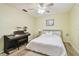 Bedroom with bright yellow walls, a piano, a bed and natural light coming from the window at 4108 Woodtrail Blvd, New Port Richey, FL 34653