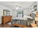Bedroom featuring wood floors, large window and classic decor at 4108 Woodtrail Blvd, New Port Richey, FL 34653